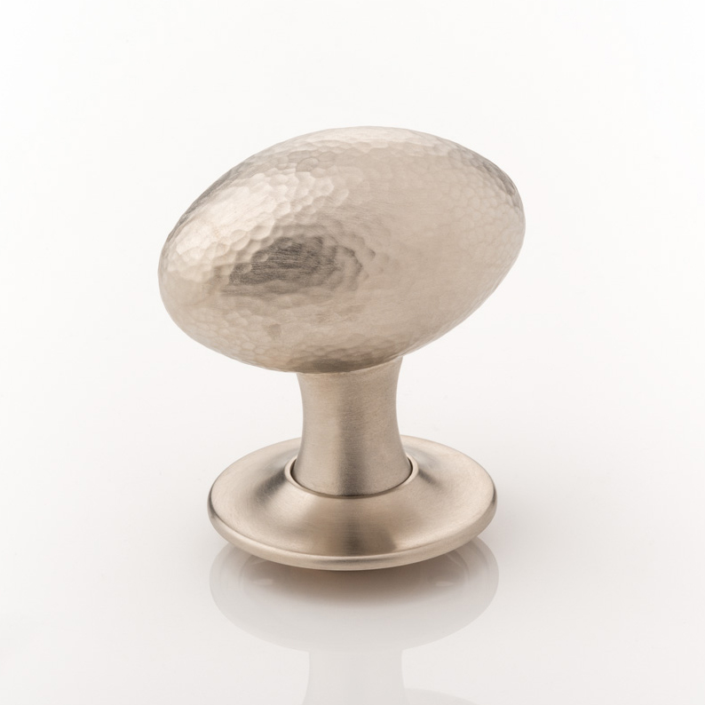 Intricately hammered solid brass oval door knob with tapered rose