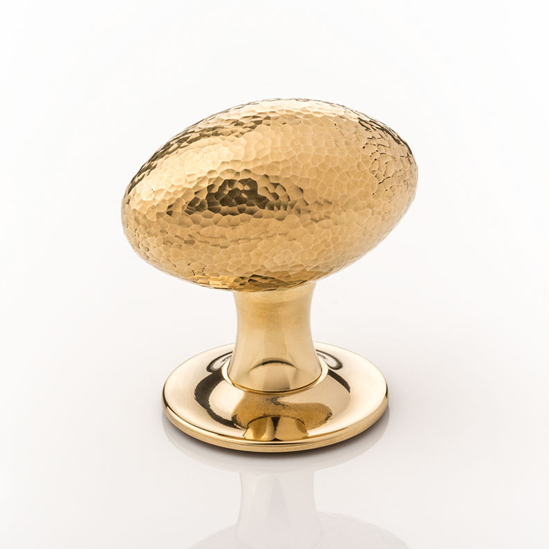 Intricately hammered solid brass oval door knob with tapered rose