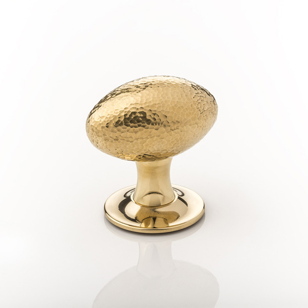 Intricately hammered solid brass oval door knob with tapered rose