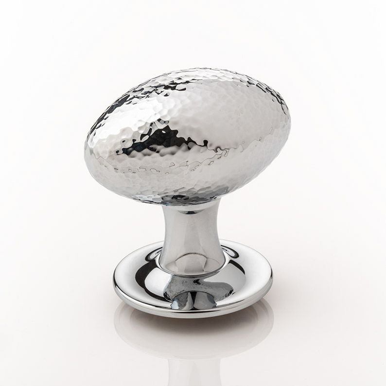 Intricately hammered solid brass oval door knob with tapered rose