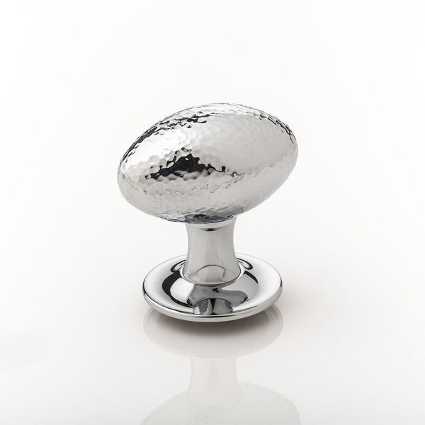 Intricately hammered solid brass oval door knob with tapered rose