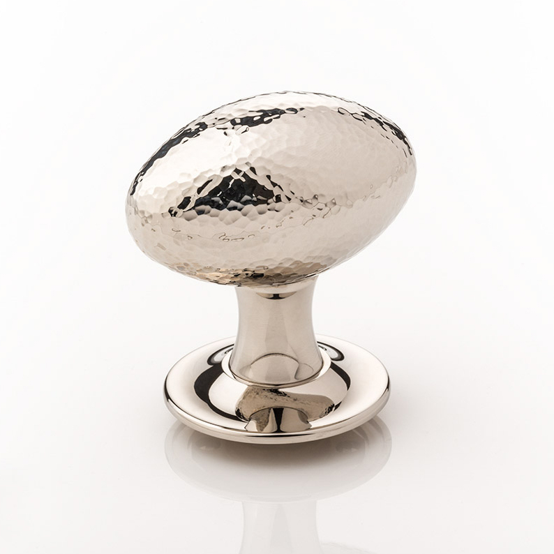 Intricately hammered solid brass oval door knob with tapered rose