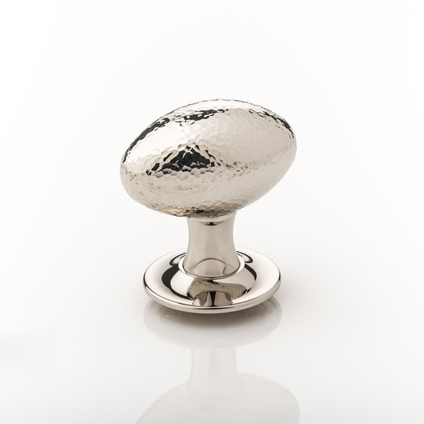 Intricately hammered solid brass oval door knob with tapered rose