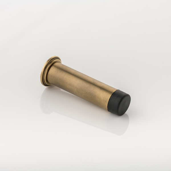 Round solid brass wall-mounted door stopper with decorative stepped plate