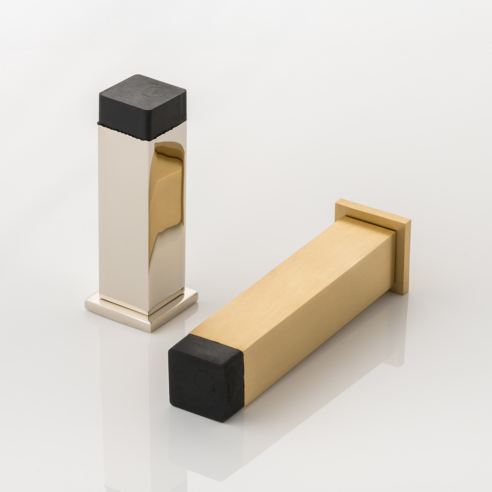 Cube II solid brass wall-mounted door stopper with decorative stepped plate