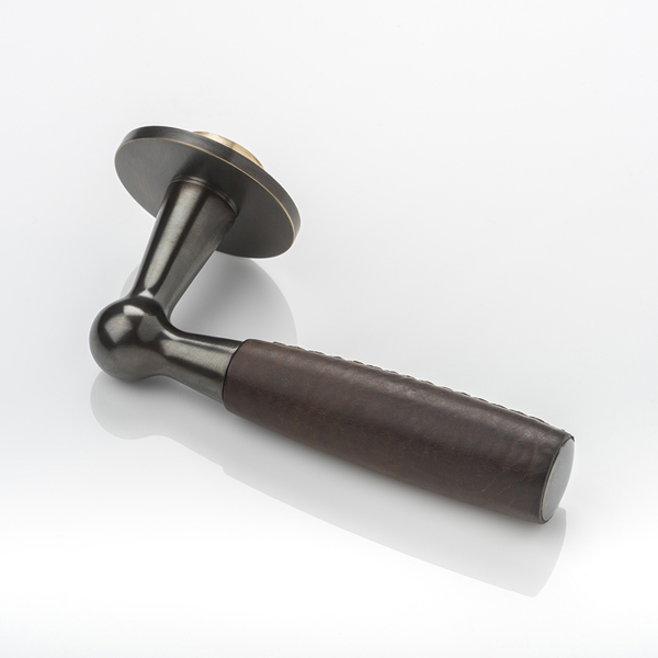Bennett solid brass door lever handle with hand stitched leather & round rose