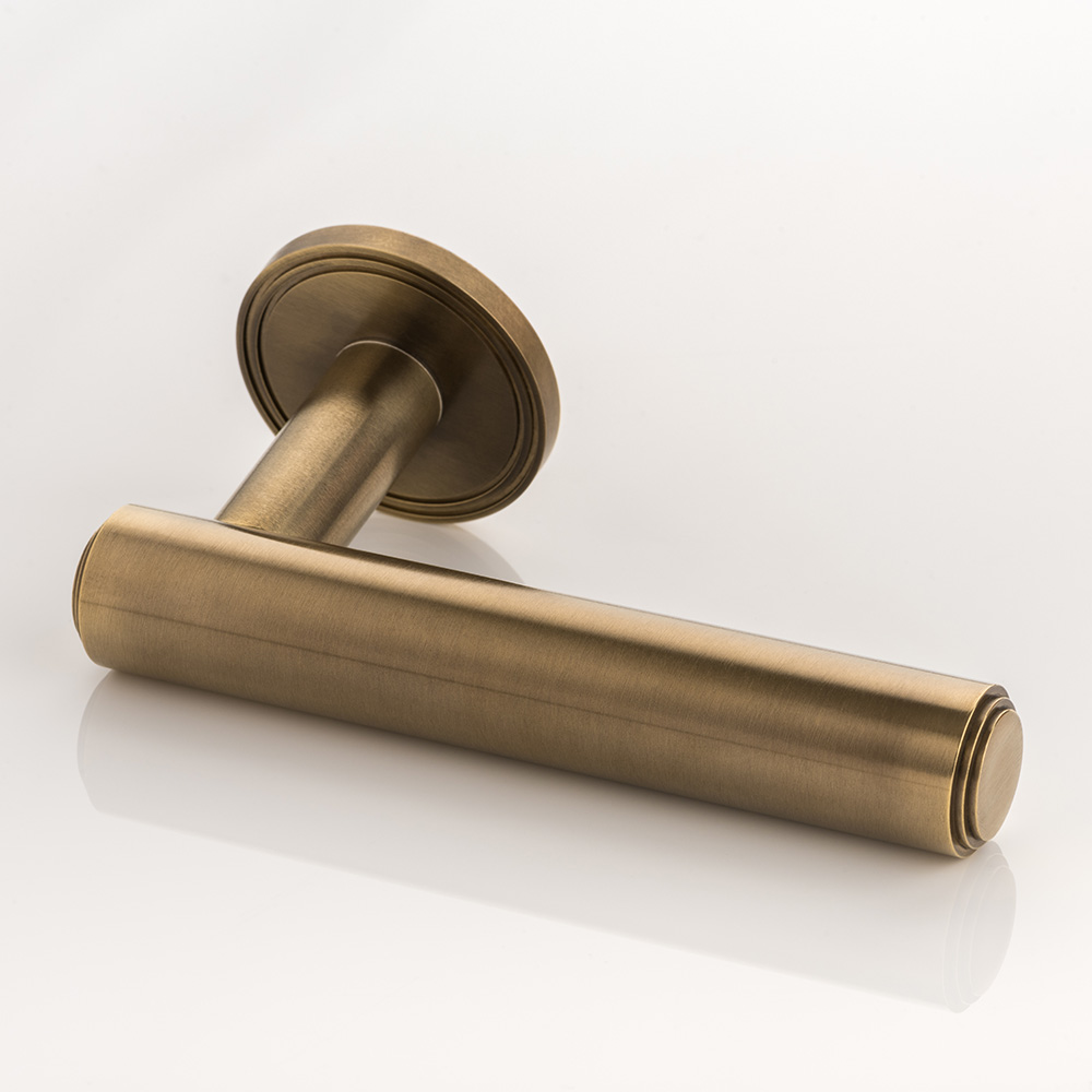 Bartlett II solid brass door lever handle with grooved rose