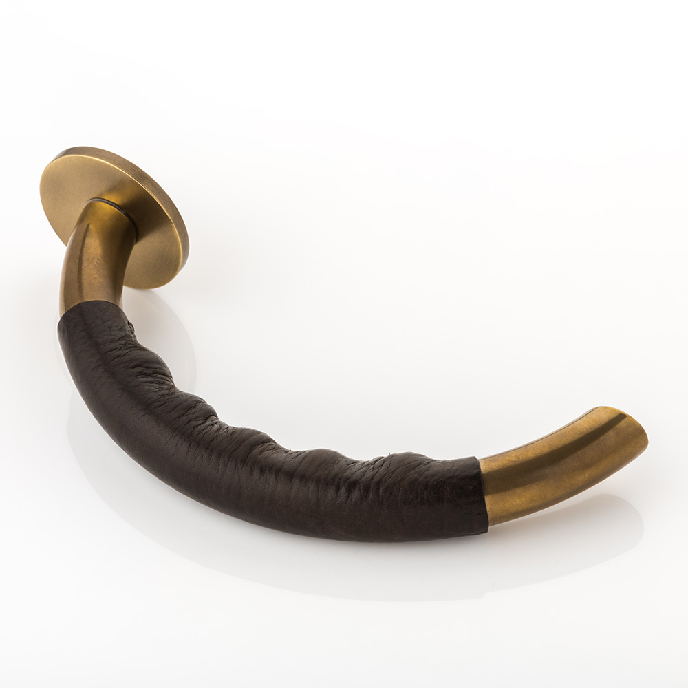 Infinity II solid brass door lever handle with hand stitched leather & round rose