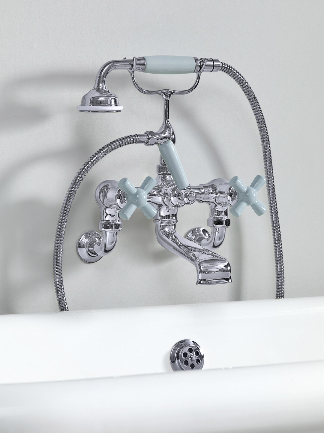 Rockwell wall-mounted bath mixer with handshower & metal/coloured crosshead taps