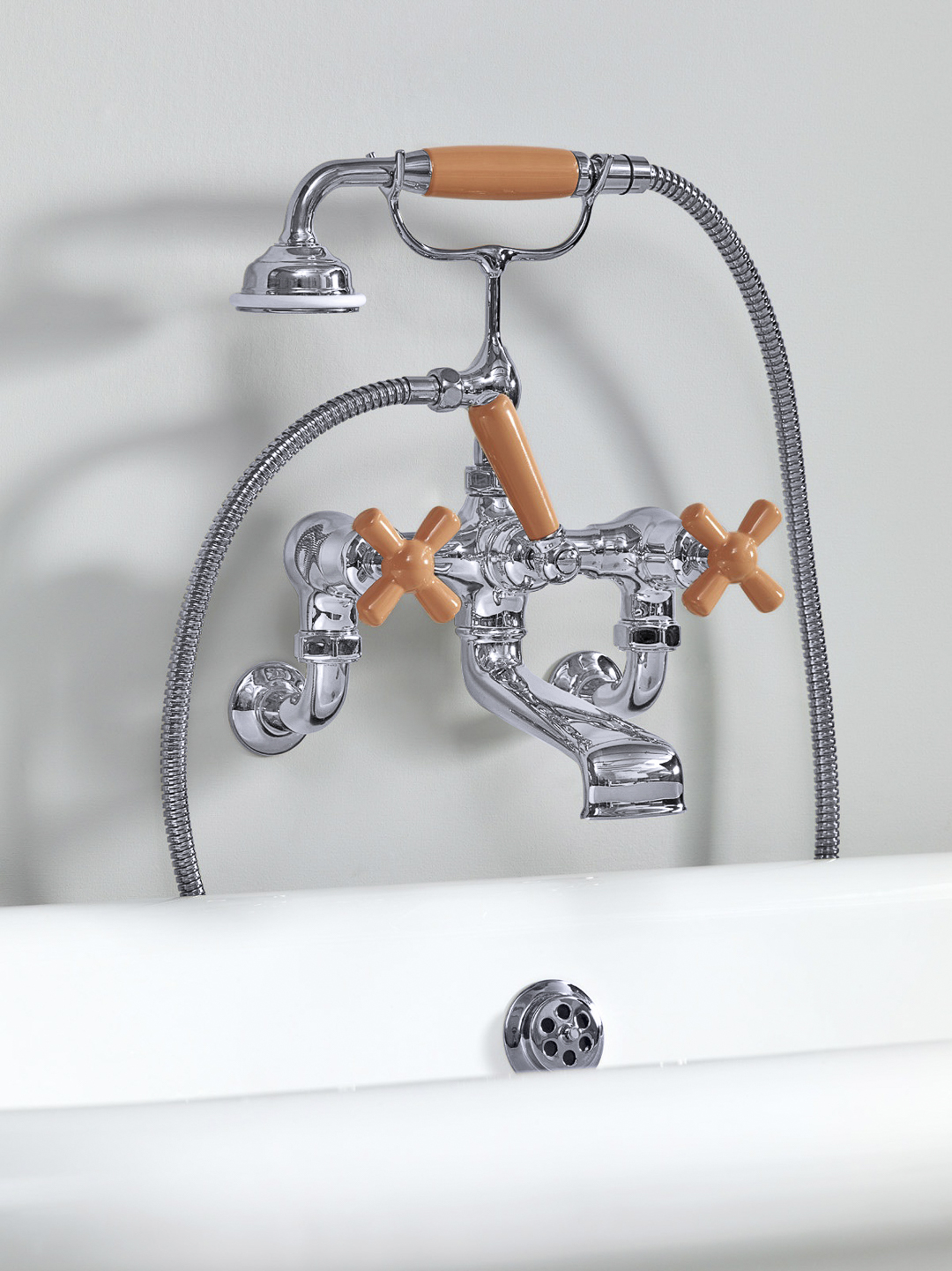 Rockwell wall-mounted bath mixer with handshower & metal/coloured crosshead taps