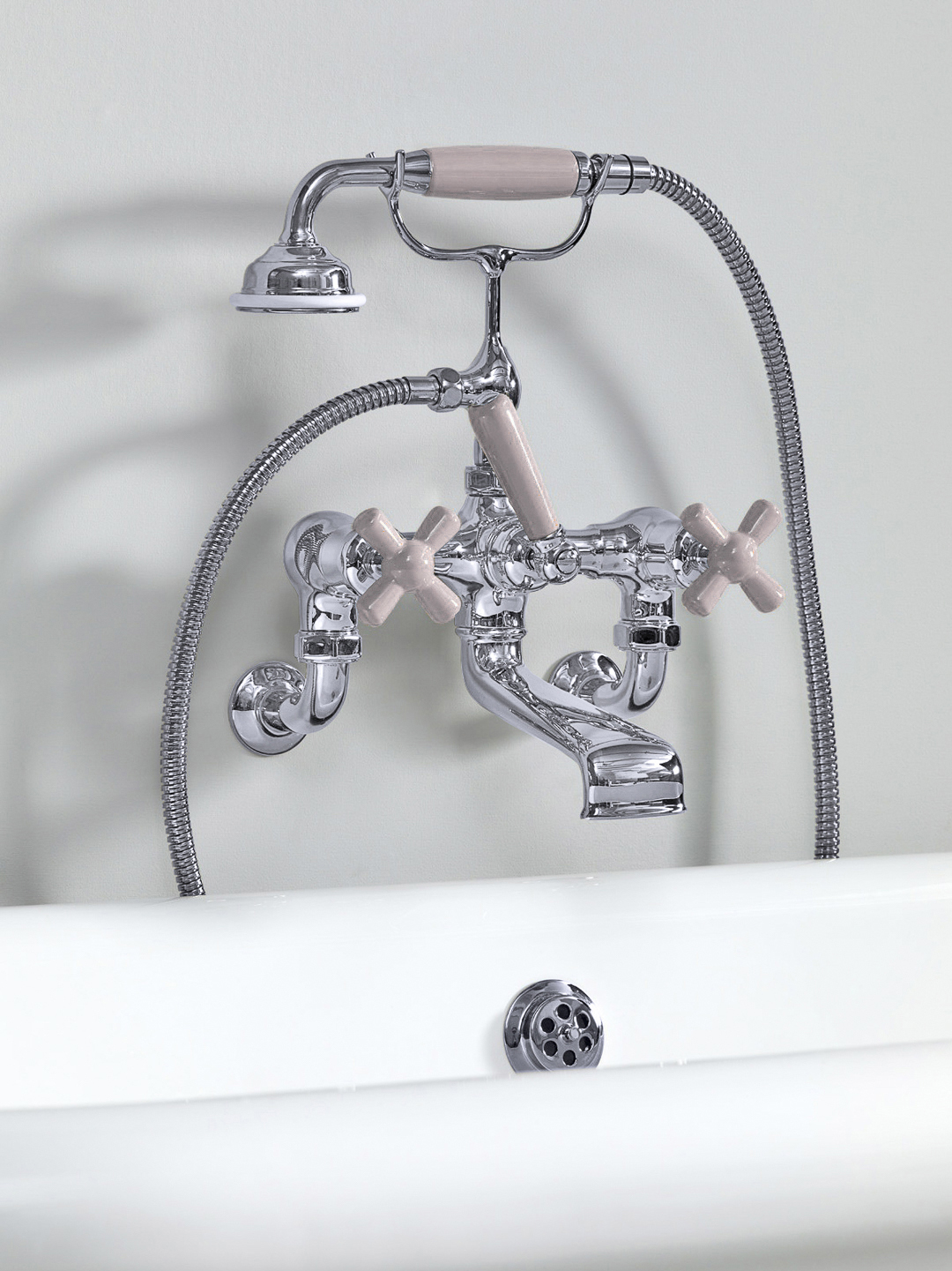 Rockwell wall-mounted bath mixer with handshower & metal/coloured crosshead taps