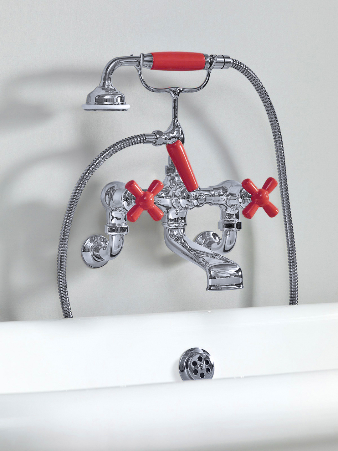 Rockwell wall-mounted bath mixer with handshower & metal/coloured crosshead taps