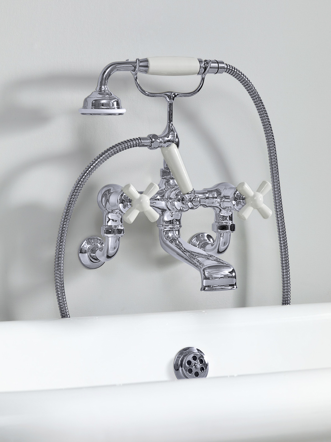 Rockwell wall-mounted bath mixer with handshower & metal/coloured crosshead taps