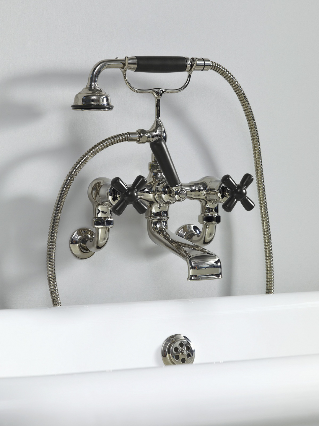 Rockwell wall-mounted bath mixer with handshower & metal/coloured crosshead taps