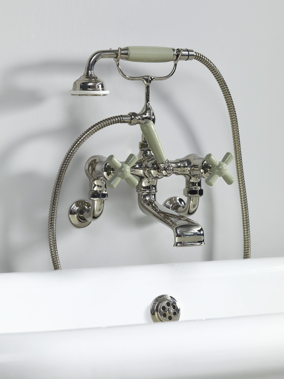 Rockwell wall-mounted bath mixer with handshower & metal/coloured crosshead taps