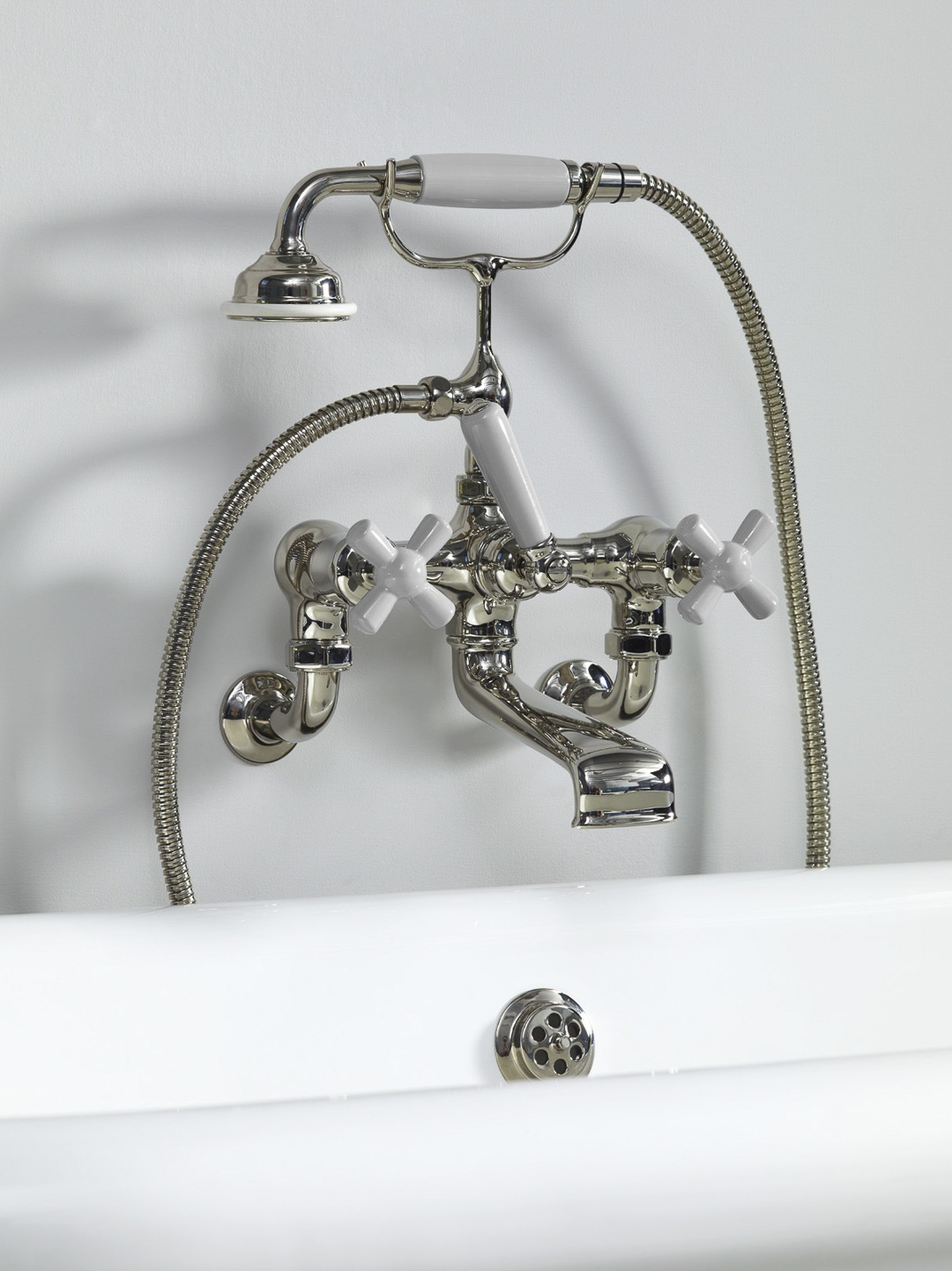 Rockwell wall-mounted bath mixer with handshower & metal/coloured crosshead taps