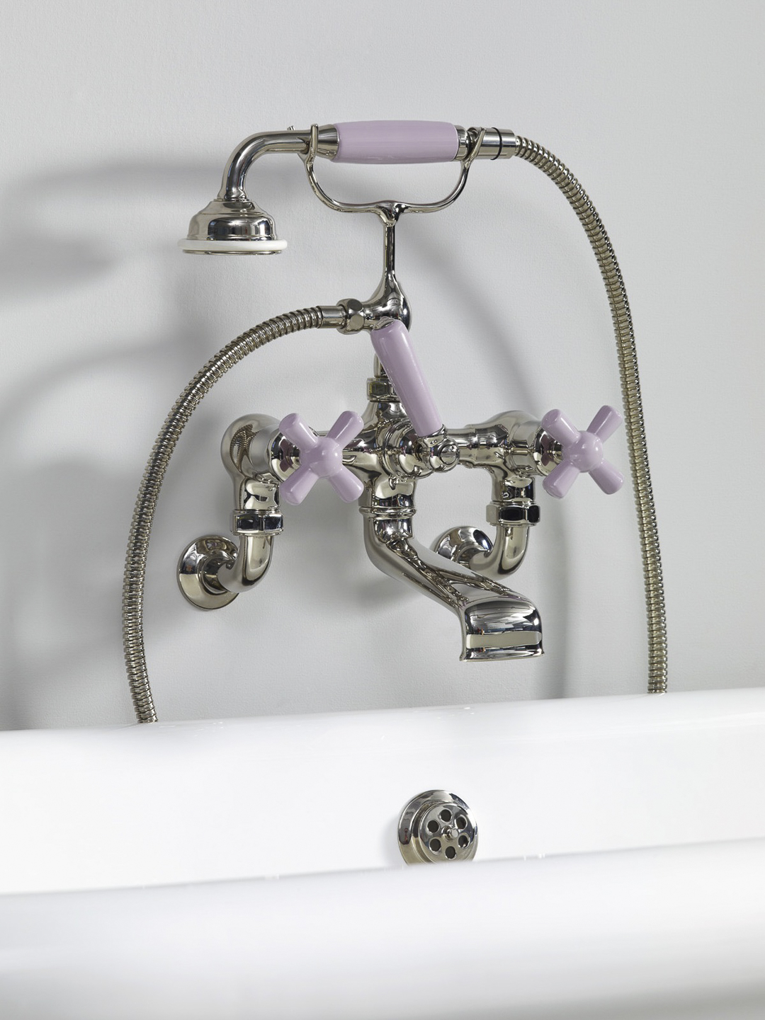 Rockwell wall-mounted bath mixer with handshower & metal/coloured crosshead taps