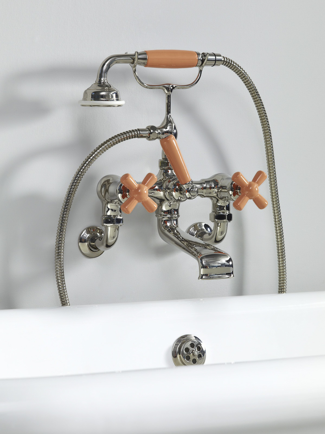 Rockwell wall-mounted bath mixer with handshower & metal/coloured crosshead taps