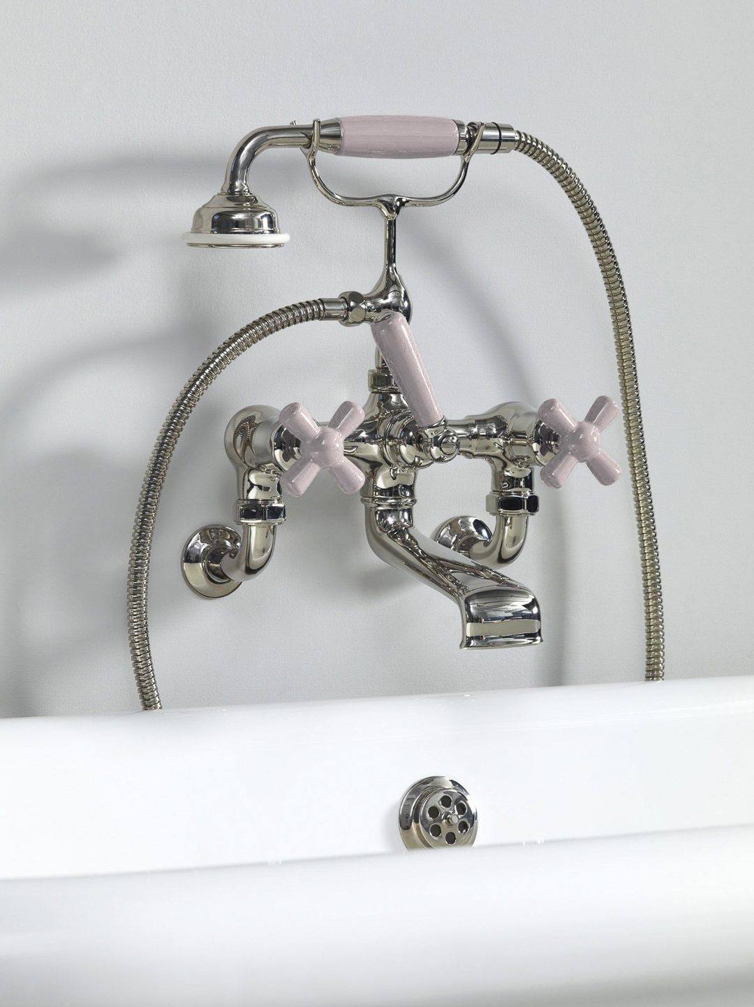 Rockwell wall-mounted bath mixer with handshower & metal/coloured crosshead taps
