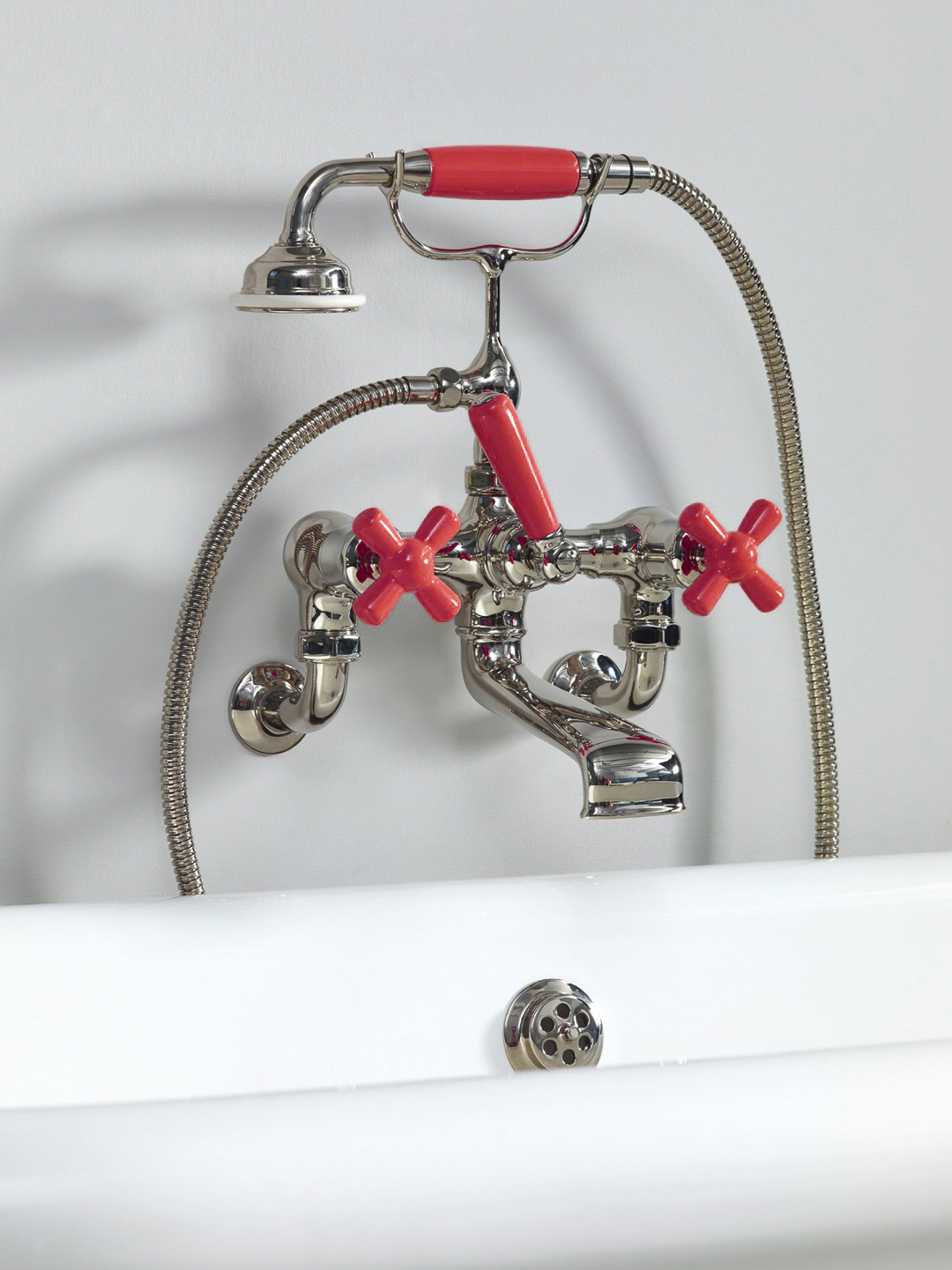 Rockwell wall-mounted bath mixer with handshower & metal/coloured crosshead taps