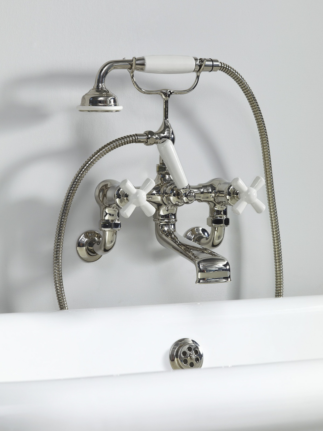Rockwell wall-mounted bath mixer with handshower & metal/coloured crosshead taps