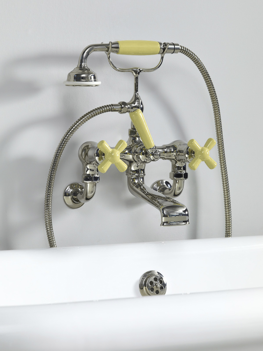 Rockwell wall-mounted bath mixer with handshower & metal/coloured crosshead taps