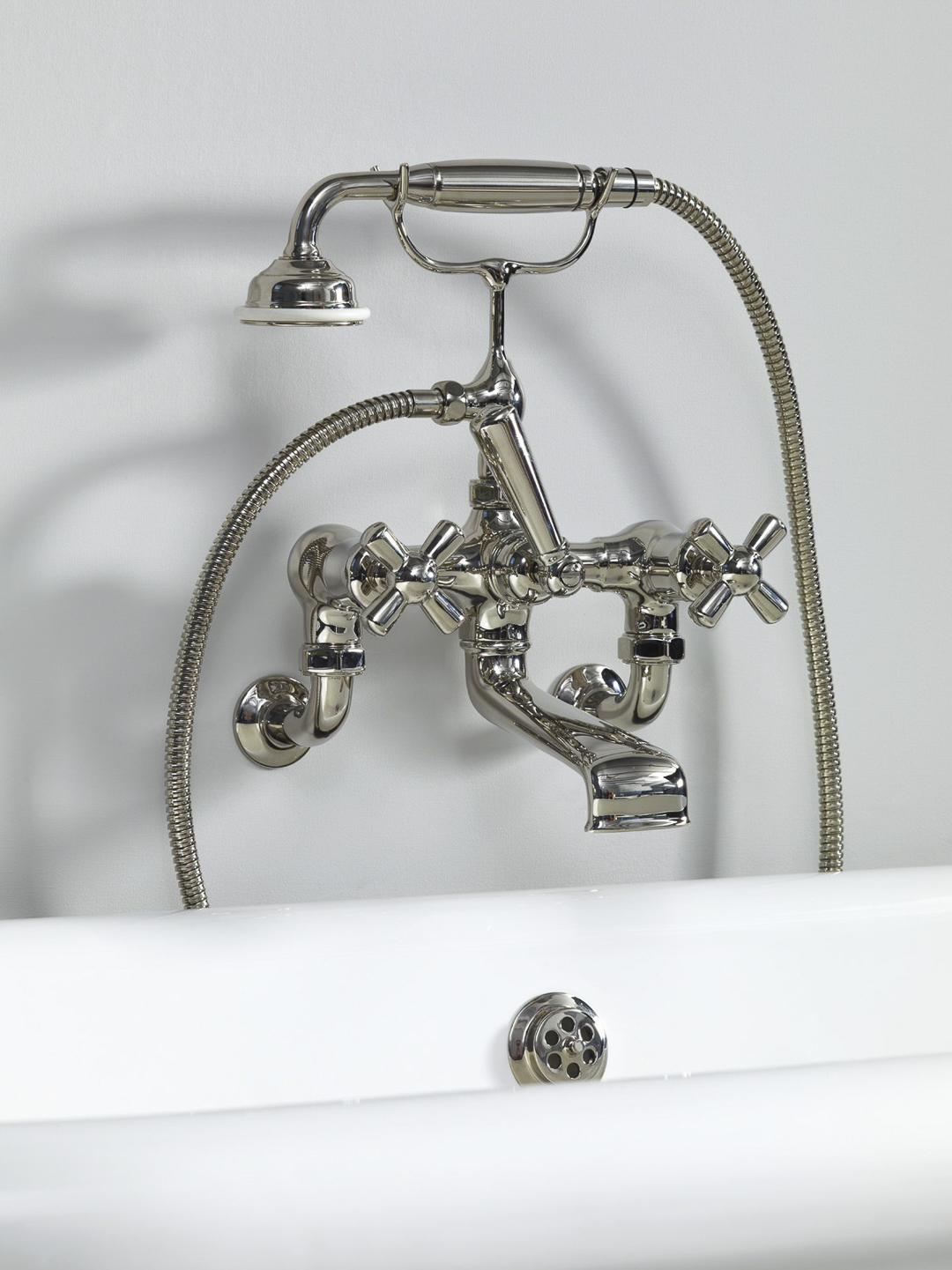 Rockwell wall-mounted bath mixer with handshower & metal/coloured crosshead taps