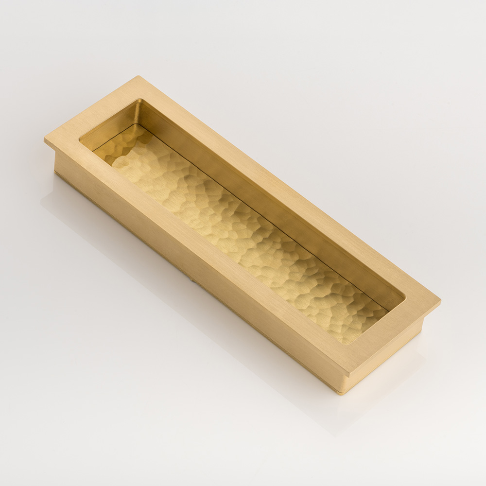 Rectangular solid brass recessed pull with hammered texture